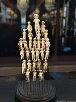 Front view of entire ceramic doll display on black base