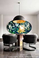 Two Cervino chairs around dining table showing leather upholstery and bronze bases