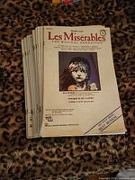 Stack of 21 Les Miserables SSA sheet music booklets