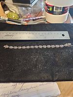 Full bracelet alongside ruler showing ~7 in length