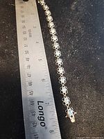 Full bracelet next to ruler showing approximately 7-inch length