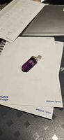 Front view of purple fluorite pendant on paper background