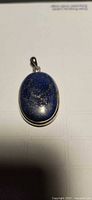 Front view showing blue lapis with pyrite flecks and sterling bezel
