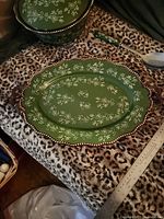 Top view of green Floral Lace Temp-tations platter on patterned surface