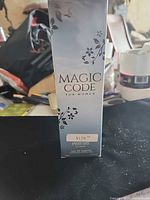 Front view of sealed Magic Code perfume box