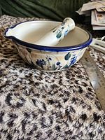 Side view of mortar with pestle inside showing pattern, spout and scale