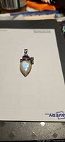 Front view of sterling silver pendant with opal, amethyst, peridot, garnet