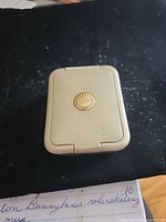 Closed pill box front showing medallion clasp