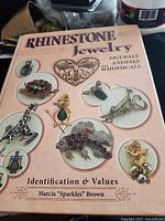 Front cover of hardcover book depicting rhinestone jewelry images