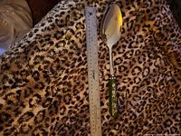 Full spoon beside 12-inch ruler showing length