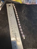 Full bracelet alongside ruler showing length