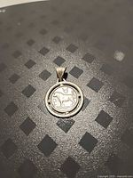 Front view of round sterling silver Taurus pendant
