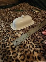 Butter dish with lid on, ruler showing length