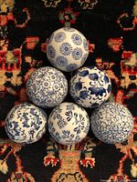 All six blue and white ceramic balls arranged in a pyramid