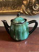 Left side view of green Blue Mountain Pottery teapot with lid