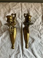 Front view of both brass sconces on cloth showing overall design and patina