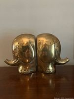 Front view of both brass elephant bookends