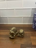 Hare and tortoise brass figurines front view on countertop