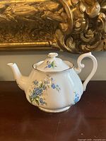 Left side view showing floral pattern and spout