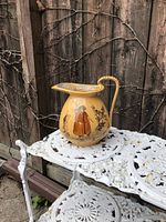 Front view of yellow ware jug showing Night Watchman scene and handle