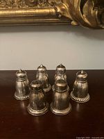 Six sterling shakers grouped front view