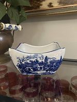 Front view of Victoria Ware blue and white curved planter showing transferware village scene