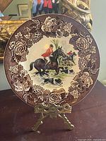 Front view showing foxhunting scene and brown floral border