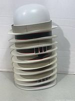 Stack of ten white plastic costume hats showing quantity and design