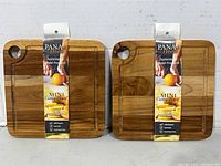 Two Pana Wood mini teak cutting boards front view with tags attached