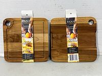 Both tagged teak cutting boards front view