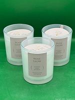 Three Rose Glow candles front view showing labels