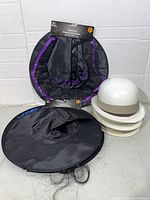 Group shot of three witch hats and stack of three white construction hats