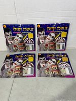 Four sealed Creepy Couples vampire makeup kits front view