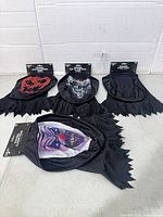 All four hooded masks laid out showing designs and packaging
