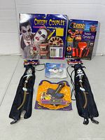 Group shot of all six sealed items: makeup kits, carving kit, and two Gruesome Ties