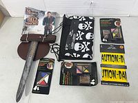 Entire lot displayed including belt & sword package, treat bag, makeup kits, caution tape