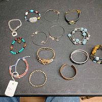 All 14 bracelets laid out on table