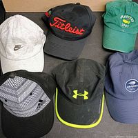Six hats laid out showing logos and colors
