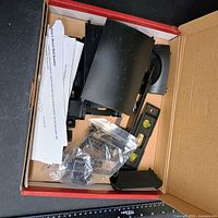 Box opened showing shelf components, hardware, instructions
