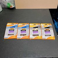 Four retail packs of Bic Cristal Xtra Smooth pens on table