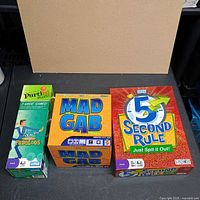 Front view of three boxed board games