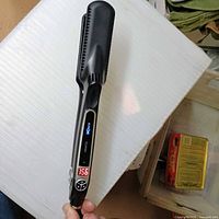 Full view of Croc Classic straightener powered on showing LED display