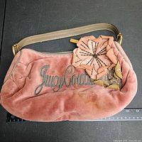 Front view showing logo, flower applique and overall bag condition