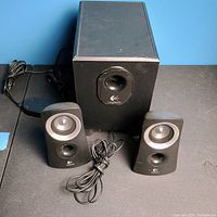 front view of subwoofer and two satellite speakers