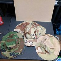 All three camouflage boonie hats displayed on table