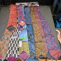 All nine ties laid flat showing fronts and brand tags