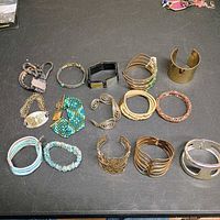 Overview of all fifteen bracelets laid out on table
