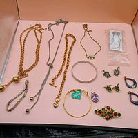 Overview of all jewellery pieces on pink surface