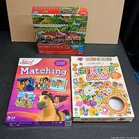 Front view of all three sealed items: Spirit Matching Game, Sticker Bomb kit, Hometown Collection puzzle