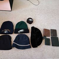 All hats, earmuff and wallets laid out